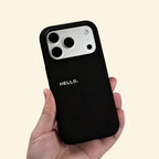 The Void Greeting case – hand-held lifestyle shot showing bold HELLO. lettering
