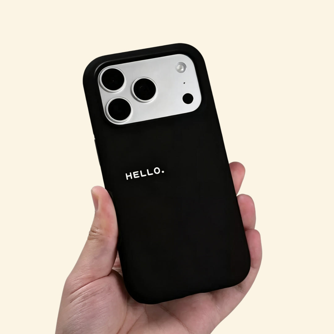 The Void Greeting case – hand-held lifestyle shot showing bold HELLO. lettering