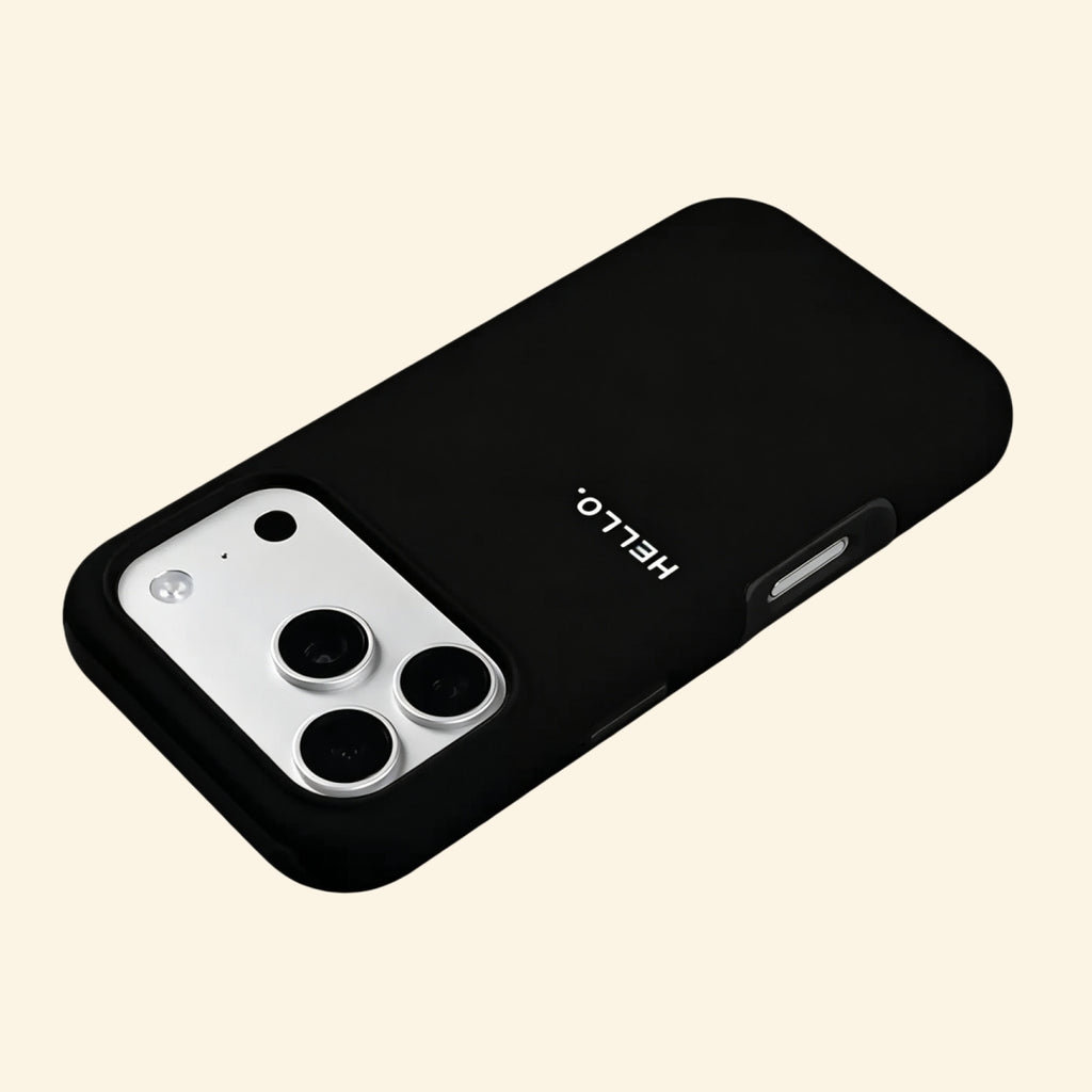 The Void Greeting case – low-angle floating view showing full matte black shell with HELLO. script