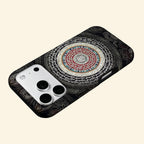 The Sacred Mandala case – low-angle floating view showing golden script and crimson mandala rings