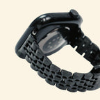 Obsidian Black Jubilee Band — close-up link detail with Apple Watch