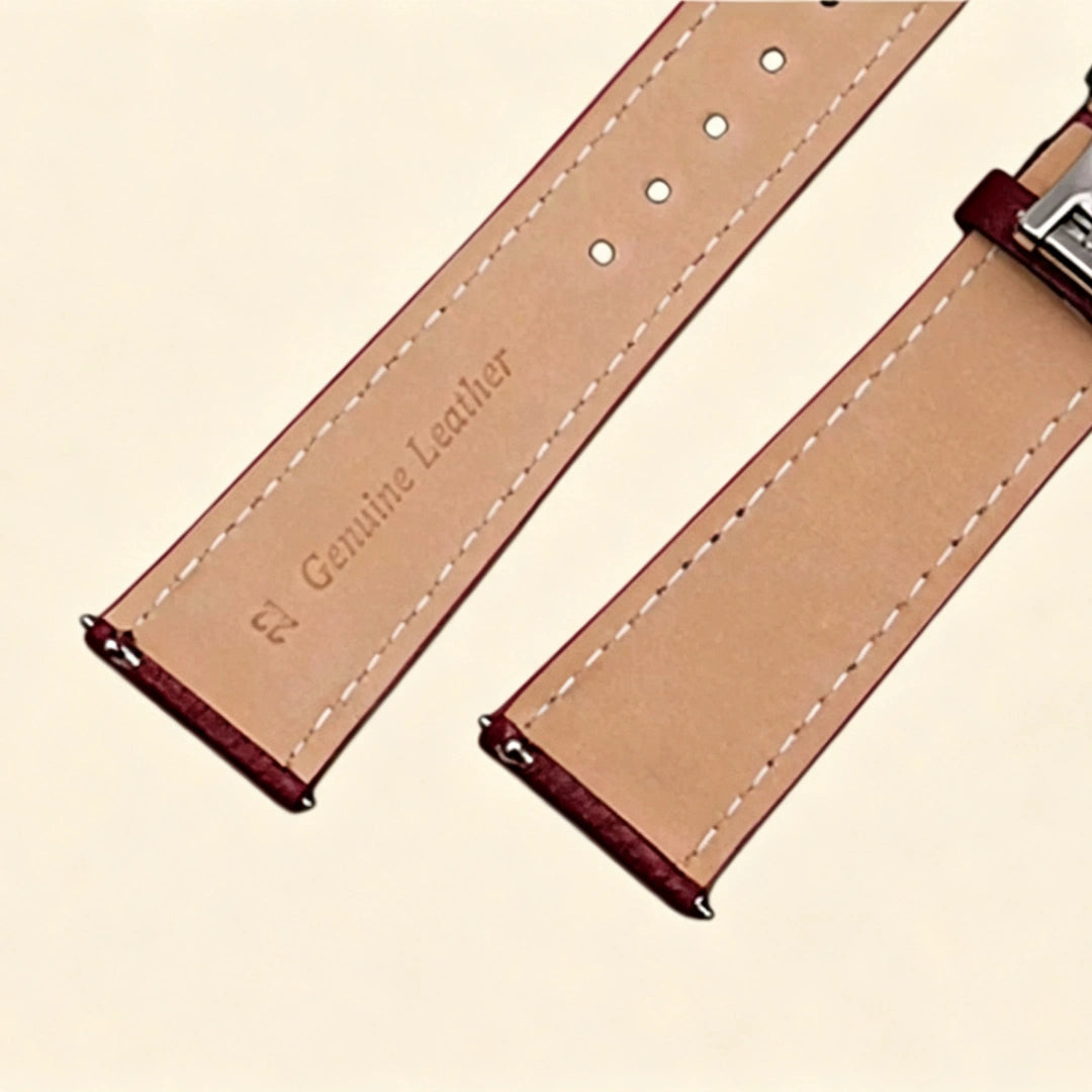 Baroque Archival Suite No. 10827 — silver engraved case with burgundy leather strap and silver cross emblem stud, three-quarter product shot on cream background