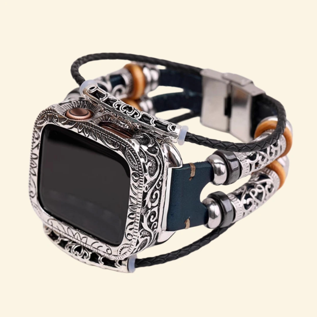 Midnight blue multi-strand braided leather Apple Watch strap lug connector — close-up showing filigree metallic tube sliders, wooden disc beads, hematite beads, and dark blue leather quick-release lug, cream background