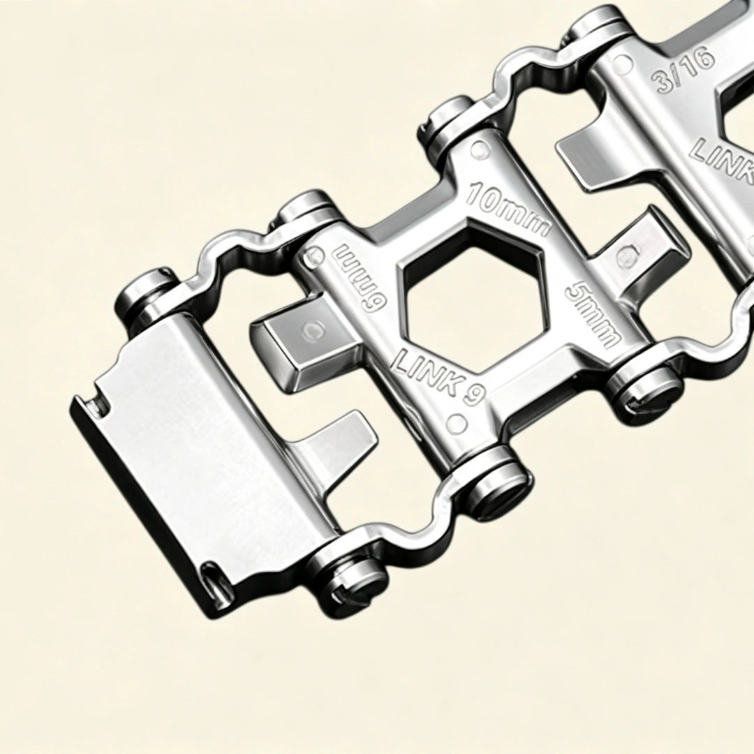 Baroque silver Apple Watch case with stainless steel multitool bracelet — close-up of foldover deployment clasp and link detail, cream background