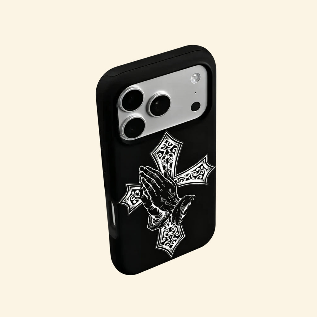 The Devotional Emblem case – hand-held lifestyle shot showing full silver cross and praying hands artwork