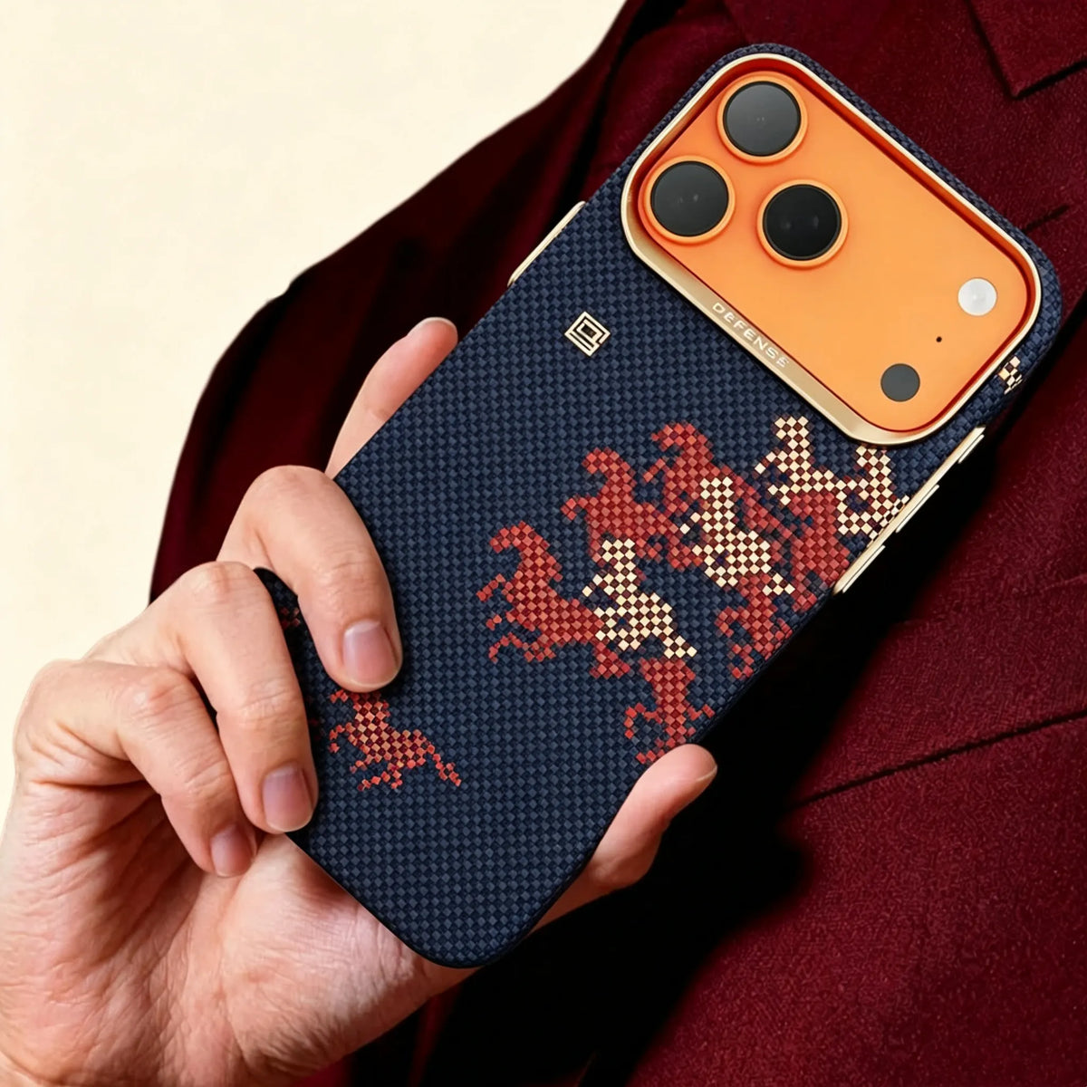 Specimen No. 10548 Navy Steed Aramid iPhone Case — lifestyle hand hold in crimson suit