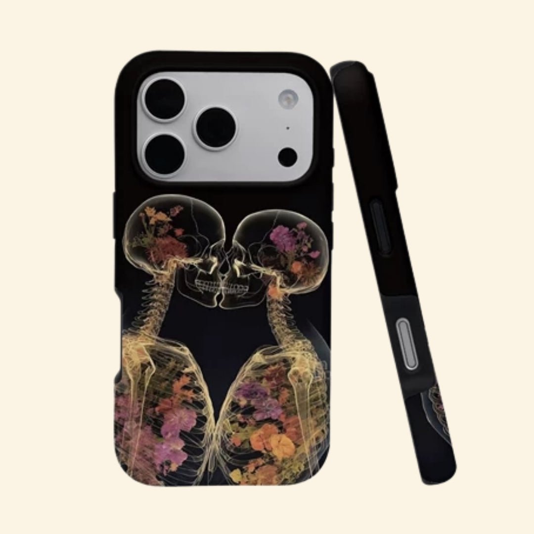 The Eternal Embrace – Kissing Skeletons & Botanical X-Ray iPhone Case - Carapace StudioPhone CaseCarapace StudioCarapace StudioCS-3424-ETERNAL-EMBRACE-1iPhone 17 Pro MaxThe Eternal Embrace case – angled floating view showing two kissing skeletons with botanical blooms in skull and rib cage on matte black