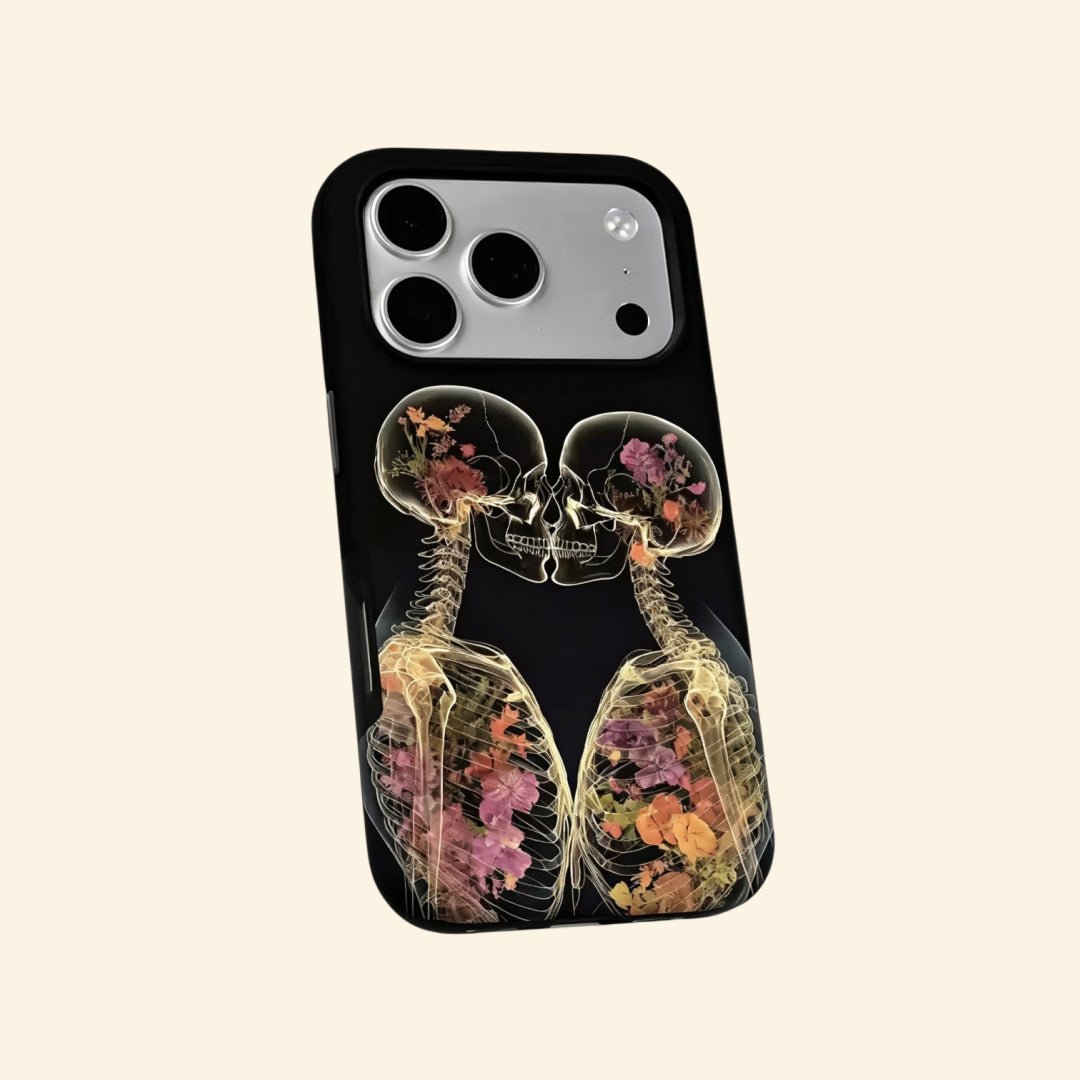 The Eternal Embrace – Kissing Skeletons & Botanical X-Ray iPhone Case - Carapace StudioPhone CaseCarapace StudioCarapace StudioCS-3424-ETERNAL-EMBRACE-5iPhone 16 Pro MaxThe Eternal Embrace case – hand-held lifestyle shot showing full kissing skeletons with vibrant pressed botanical blooms
