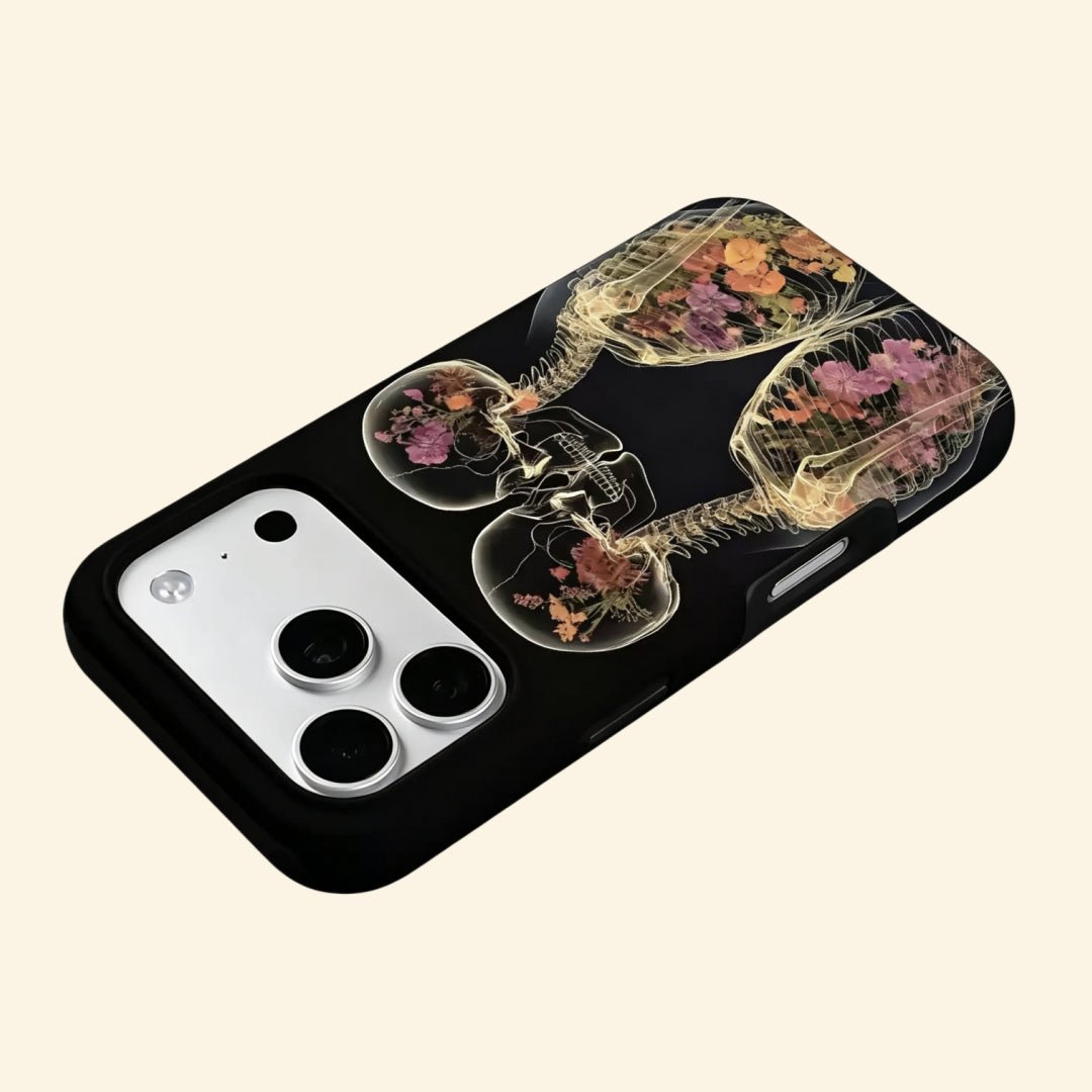 The Eternal Embrace – Kissing Skeletons & Botanical X-Ray iPhone Case - Carapace StudioPhone CaseCarapace StudioCarapace StudioCS-3424-ETERNAL-EMBRACE-5iPhone 16 Pro MaxThe Eternal Embrace case – second angled floating view showing golden X-ray bone translucency and floral cavity detail