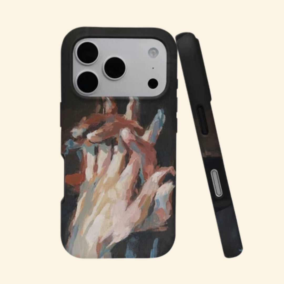 The Silent Touch case – angled floating view showing intertwined hands oil painting with warm ochre and blush impasto strokes on matte black
