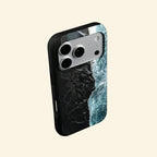 The Basalt Shore – Volcanic Black Sand & Ice-Blue Sea iPhone Case - Carapace StudioPhone CaseCarapace StudioCarapace StudioCS-3626-BASALT-SHORE-5iPhone 16 Pro MaxThe Basalt Shore case – front flat lay with side profile showing full basalt shore aerial print and dual-layer shell
