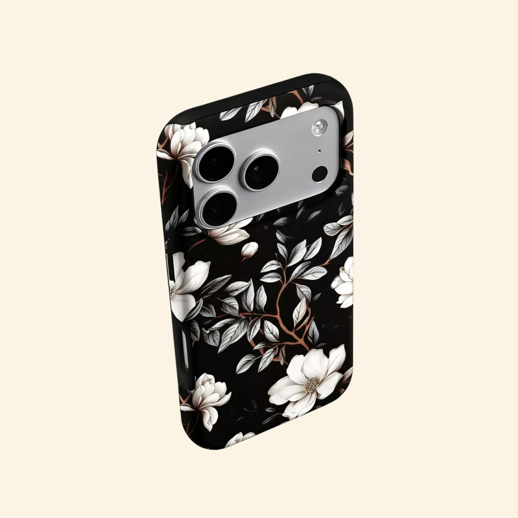 The Midnight Bloom case – angled floating side view showing magnolia petal gradient and warm branch detail