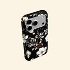 The Midnight Bloom case – angled floating side view showing magnolia petal gradient and warm branch detail