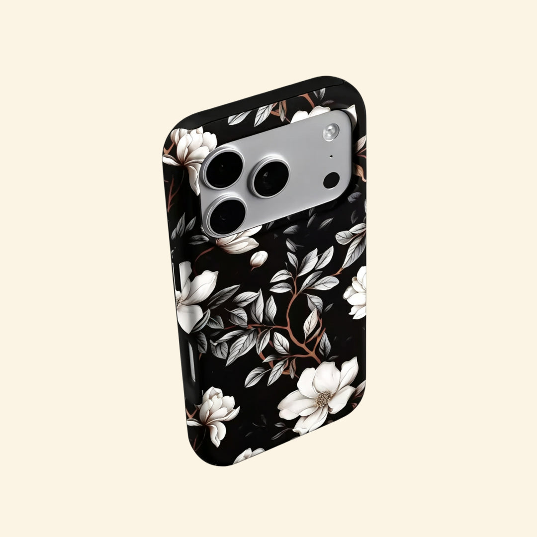 The Midnight Bloom case – angled floating side view showing magnolia petal gradient and warm branch detail