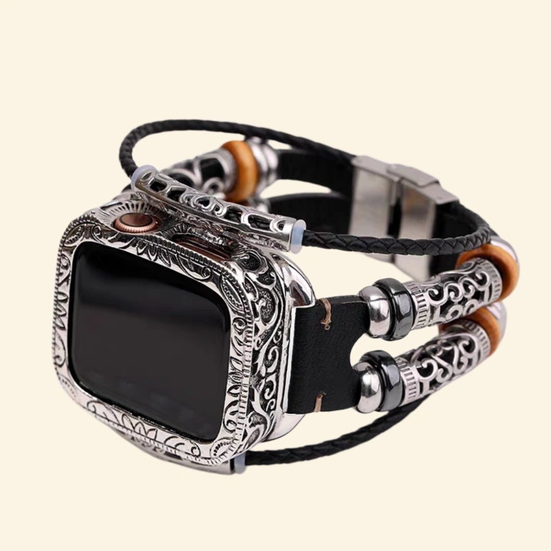 Tribal braided leather Apple Watch strap — close-up of brushed stainless steel fold-over clasp closed, showing multi-strand leather and bead construction with Apple Watch back sensor visible