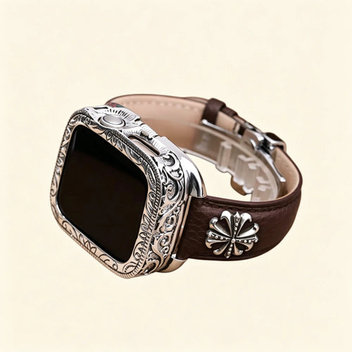 Dark espresso brown pebble-grained leather Apple Watch strap — diagonal close-up showing stainless steel butterfly deployment clasp open, double-push button mechanism detail
