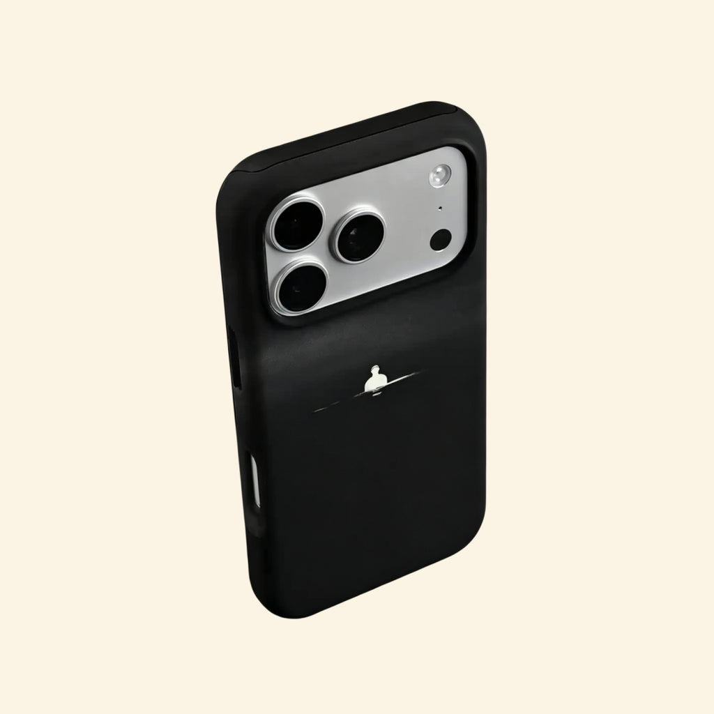 The Silent Void case – hand-held lifestyle shot showing solitary figure glowing against deep obsidian matte black