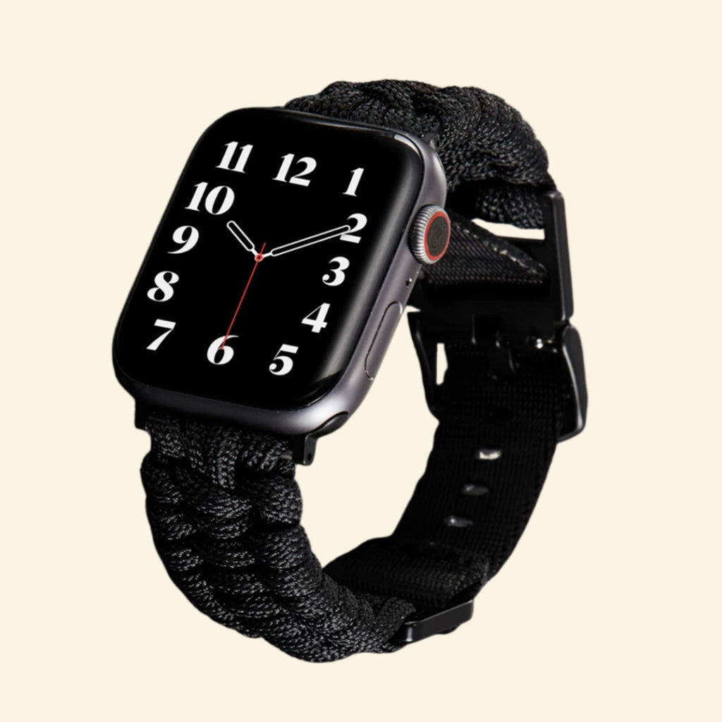 Stealth Black Paracord Braided Apple Watch Band — size comparison flat lay showing 38mm and 42mm variants on watch, Specimen No. 10010