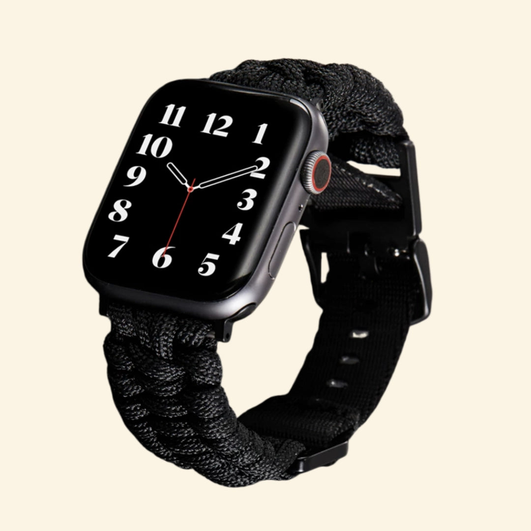 Stealth Black Paracord Braided Apple Watch Band — size comparison flat lay showing 38mm and 42mm variants on watch, Specimen No. 10010