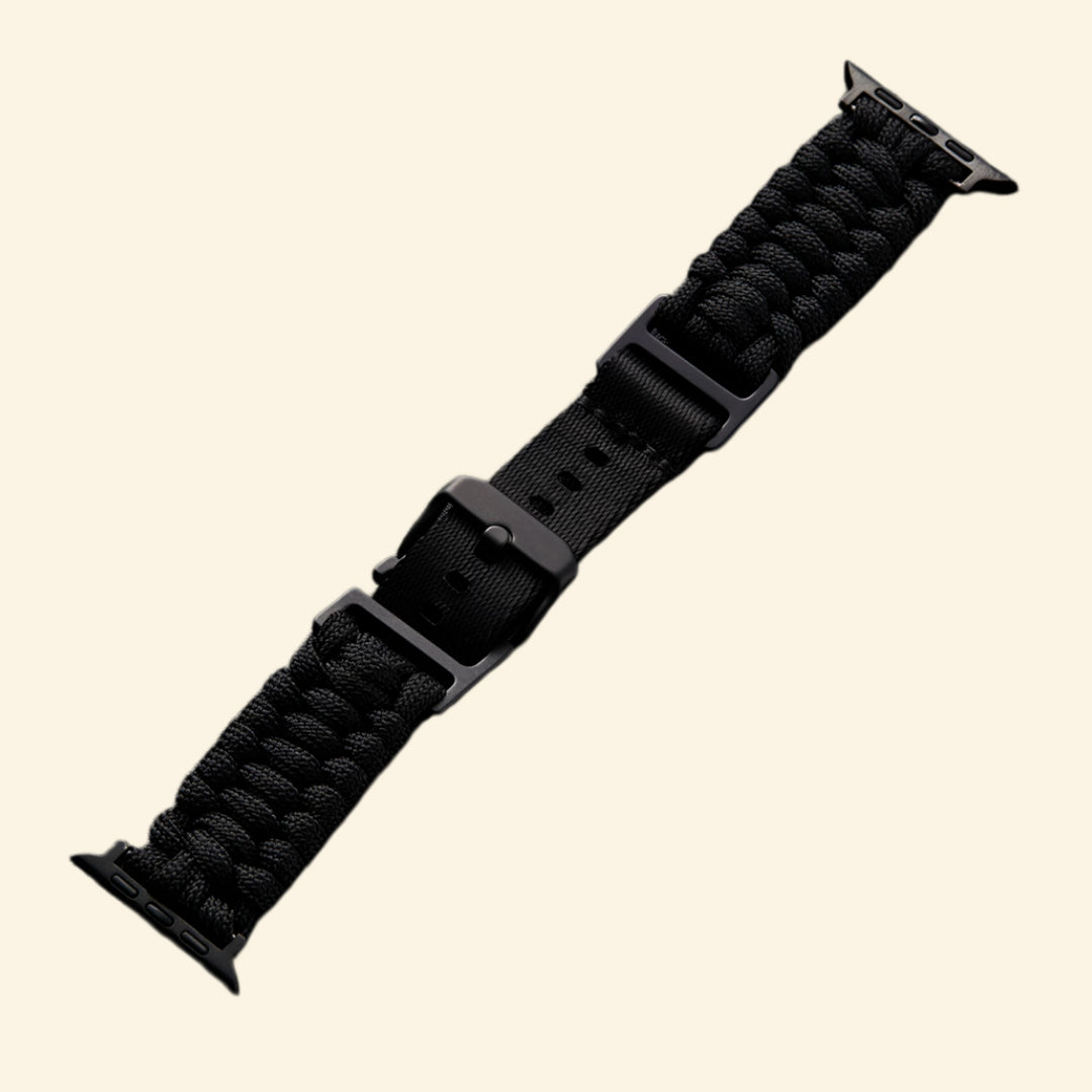 Stealth Black Paracord Braided Apple Watch Band — angled side view on Apple Watch Ultra showing full braid texture, Specimen No. 10010