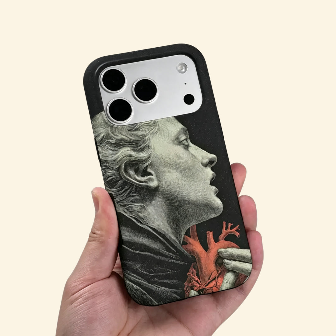 The Anatomy of Passion case – low-angle side view showing camera island and cross-hatching engraving detail of statue and heart