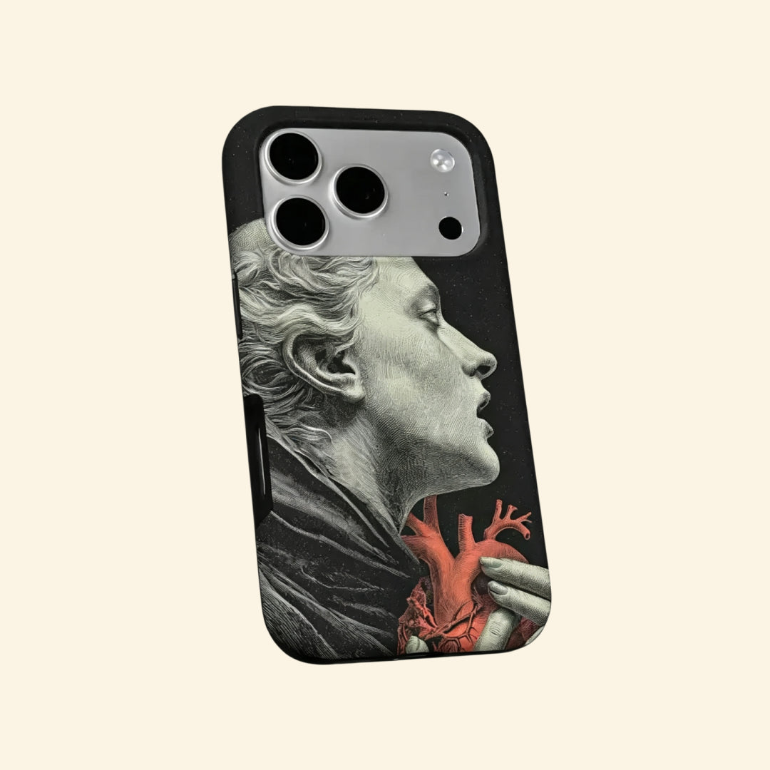 The Anatomy of Passion case – hand-held lifestyle shot showing full classical statue silhouette with crimson anatomical heart detail