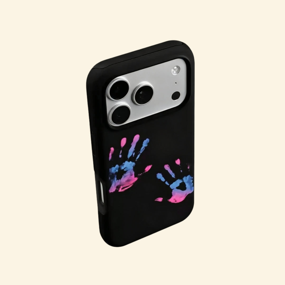 The Neon Impressions case – hand-held lifestyle shot showing full magenta, purple, and electric cyan handprints