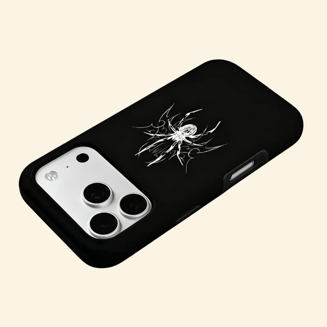 The Silver Arachnid case – hand-held lifestyle shot showing full silver cyber sigilism spider centered on obsidian matte black