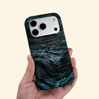 The Ancient Sediment case – second angled floating view showing sweeping petrified wood grain layers and moody teal depth