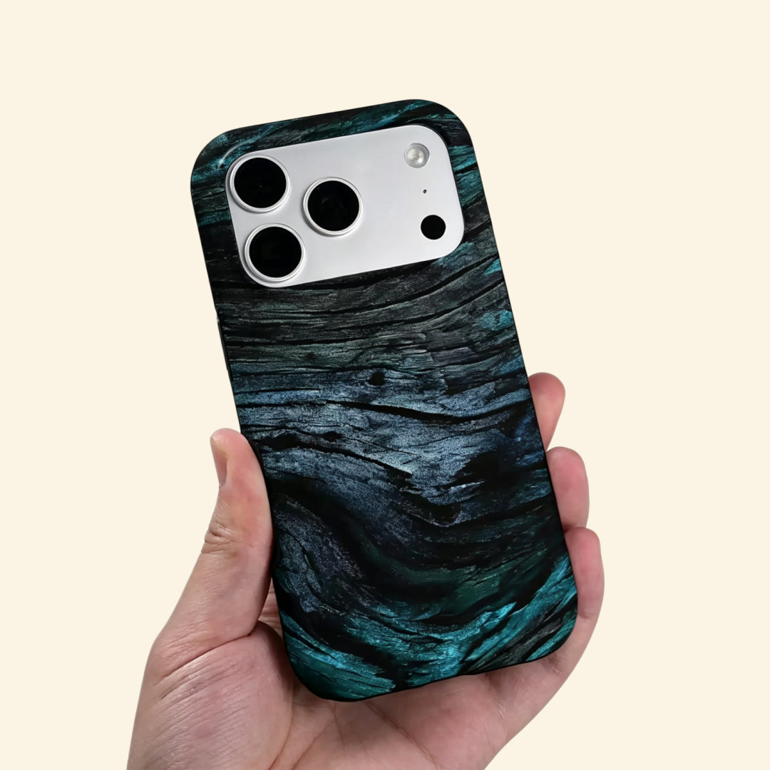 The Ancient Sediment case – second angled floating view showing sweeping petrified wood grain layers and moody teal depth