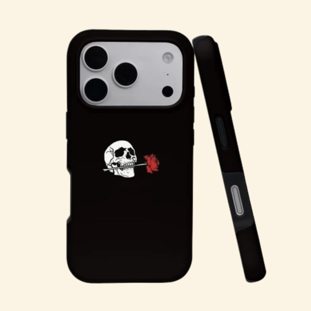 The Eternal Vow case – hand-held lifestyle shot showing retro white skull biting vivid red rose centered on deep obsidian matte black