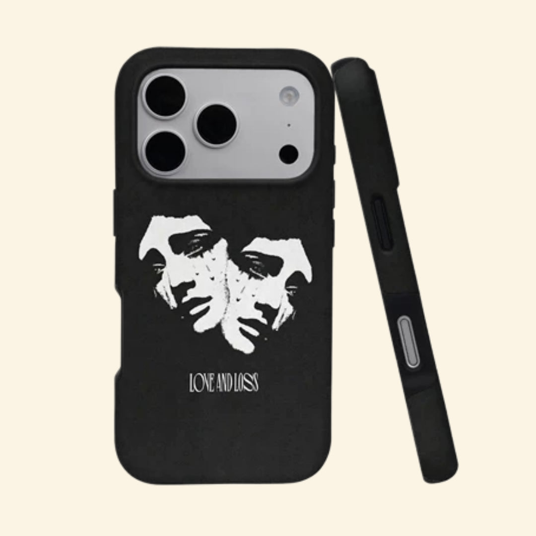 The Dual Tragedy case – angled floating view showing two weeping classical marble faces with gothic Love and Loss typography on pitch-black matte