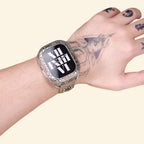 Baroque silver case on tattooed wrist — close-up showing full scrollwork bezel and khaki canvas strap detail