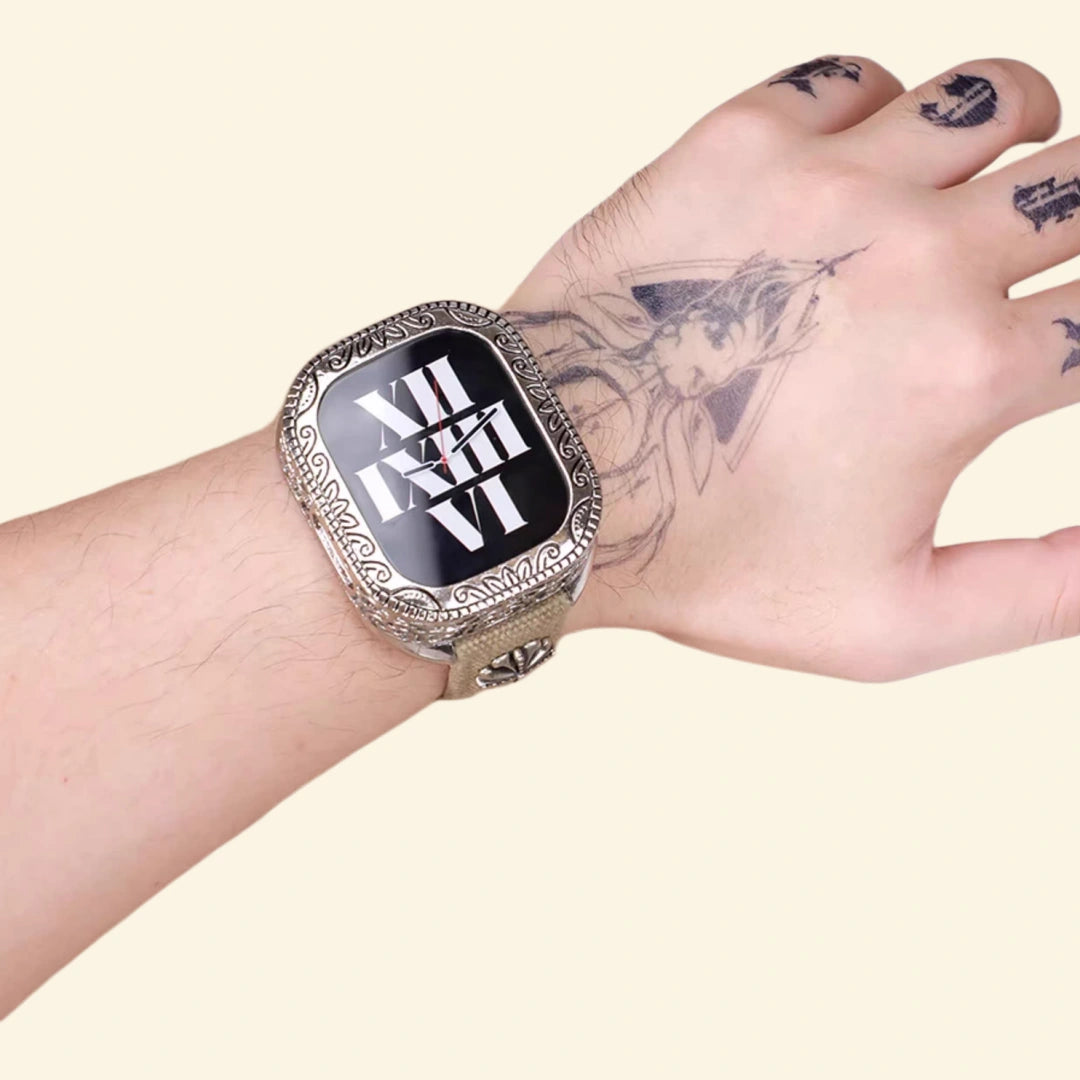 Baroque silver case on tattooed wrist — close-up showing full scrollwork bezel and khaki canvas strap detail