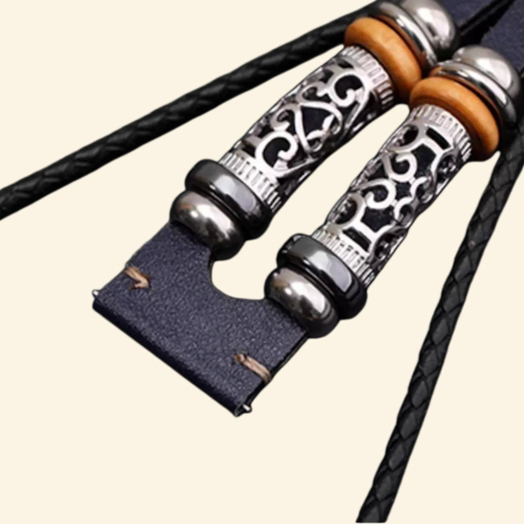 Midnight blue braided leather Apple Watch strap clasp end — close-up showing brushed stainless steel fold-over clasp closed on multi-strand midnight blue leather with wooden and silver bead accents, cream background