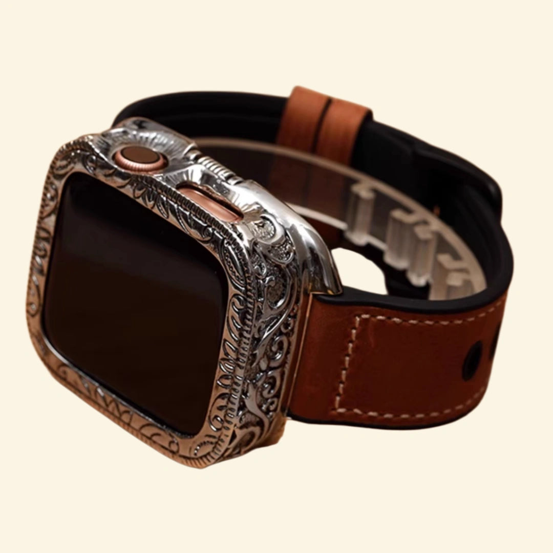 Baroque silver Apple Watch case with brown leather hybrid strap — overhead flat lay showing full strap length and matte black buckle