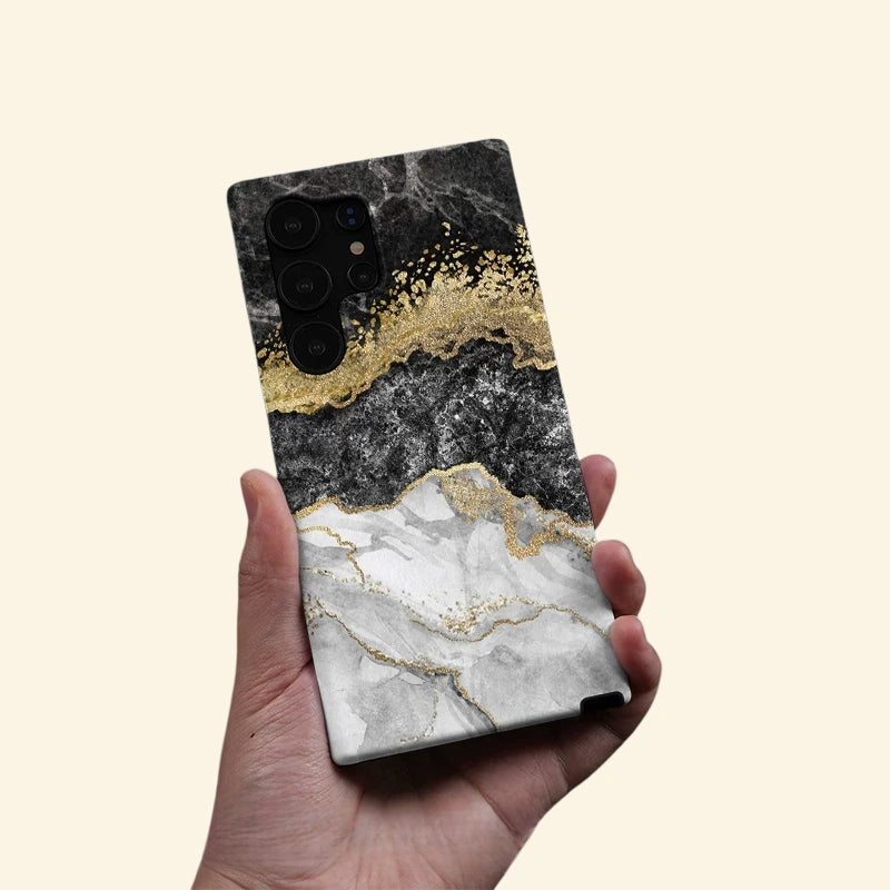 Gold Vein Obsidian Marble Case — held in hand lifestyle shot
