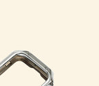 Polished Chrome Silver Rivet Apple Watch Case — angled overhead view showing rivet corners, Specimen No. 10545